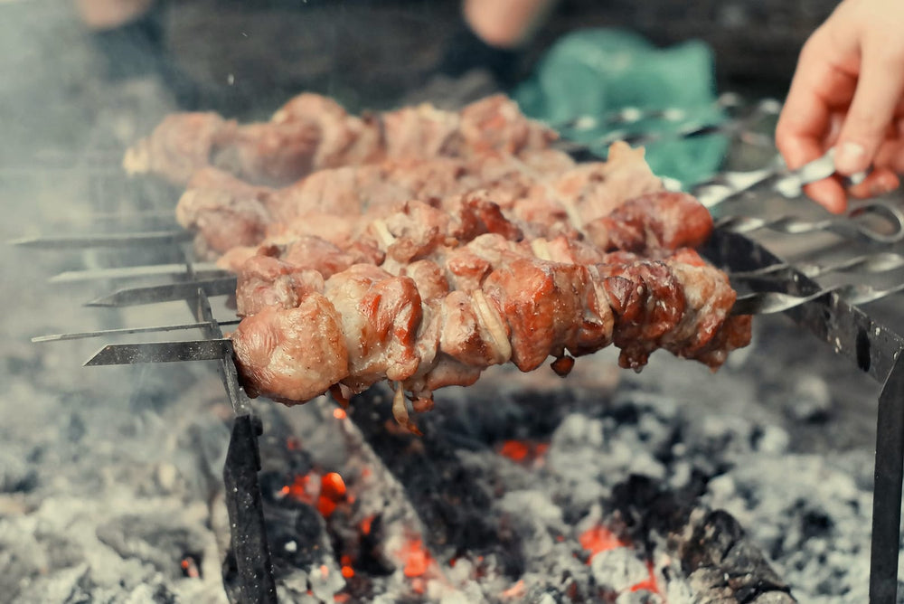 Meat skewers over glowing charcoal